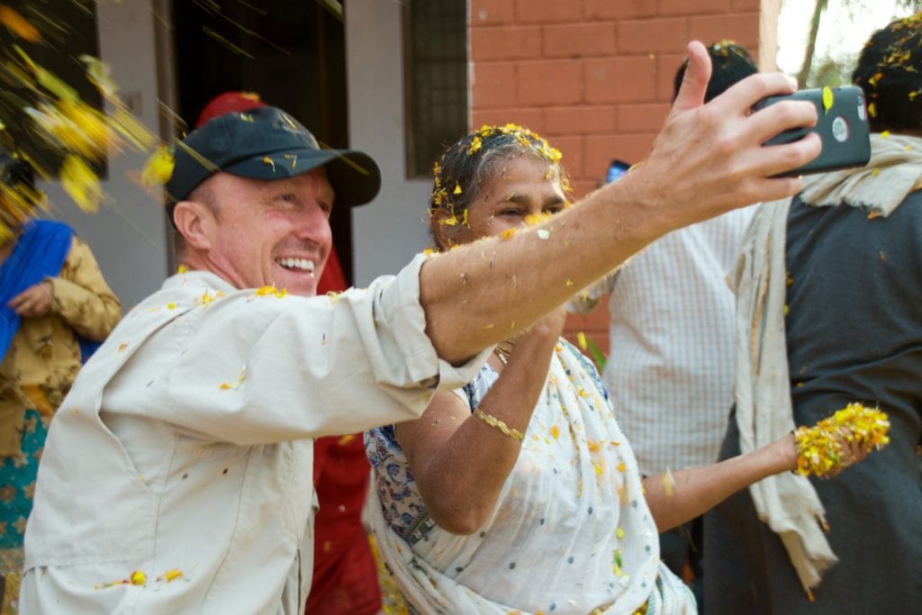 Karl, Tour Leader, takes a selfie with a joyous widow 