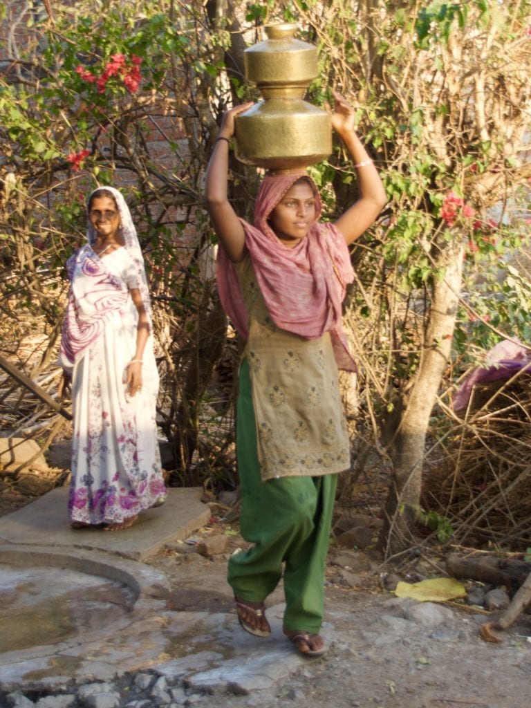 Carrying water in village near Kavant 
